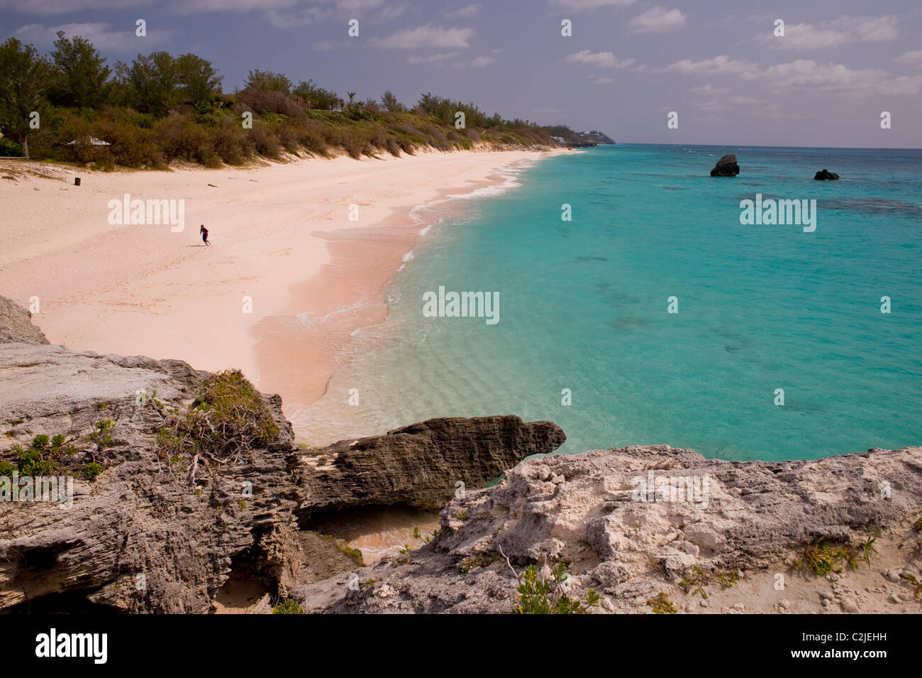 A solitary man runs on a deserted South Coast beach, Warwick parish, Bermuda. Stock Photo
