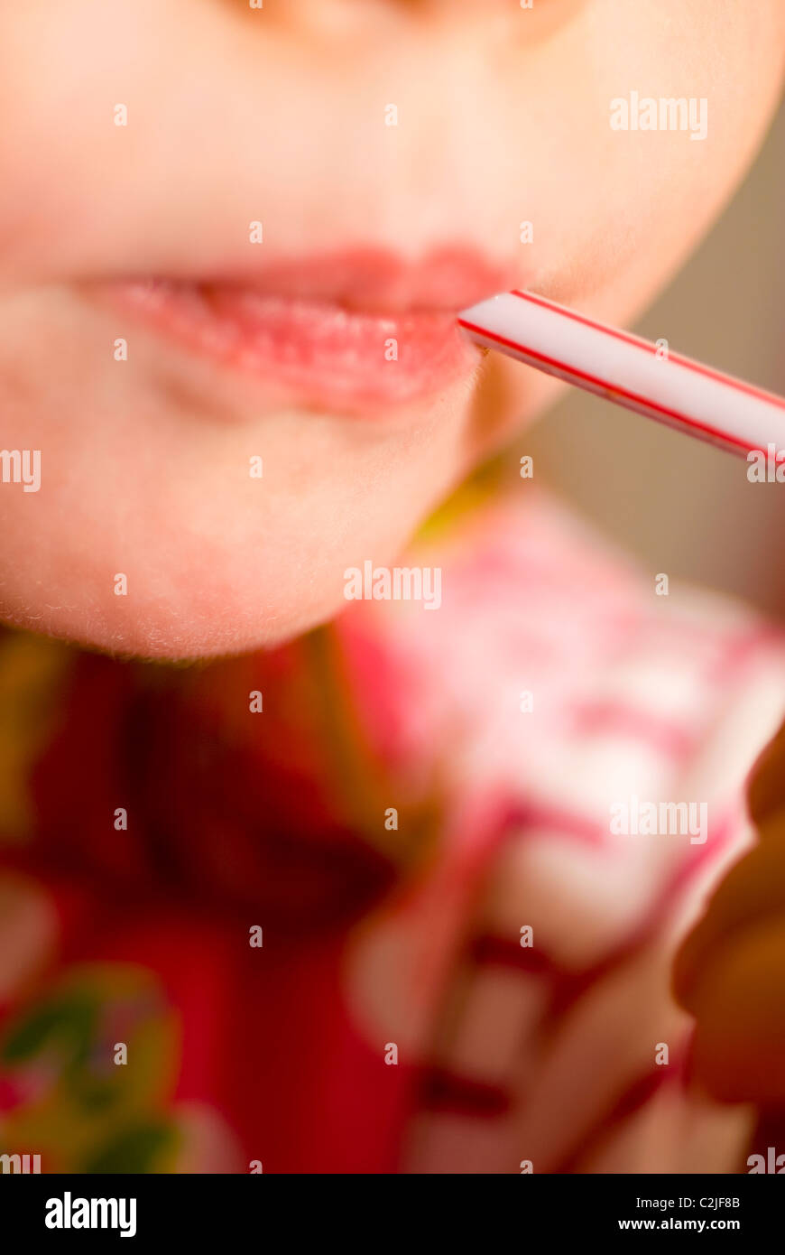 Close up of a mouth drinking with a straw Stock Photo Alamy