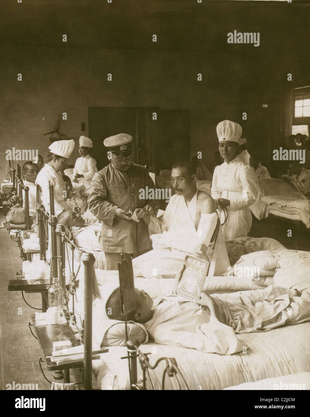 Nurses and a doctor attending wounded soldiers on a hospital ward Stock ...