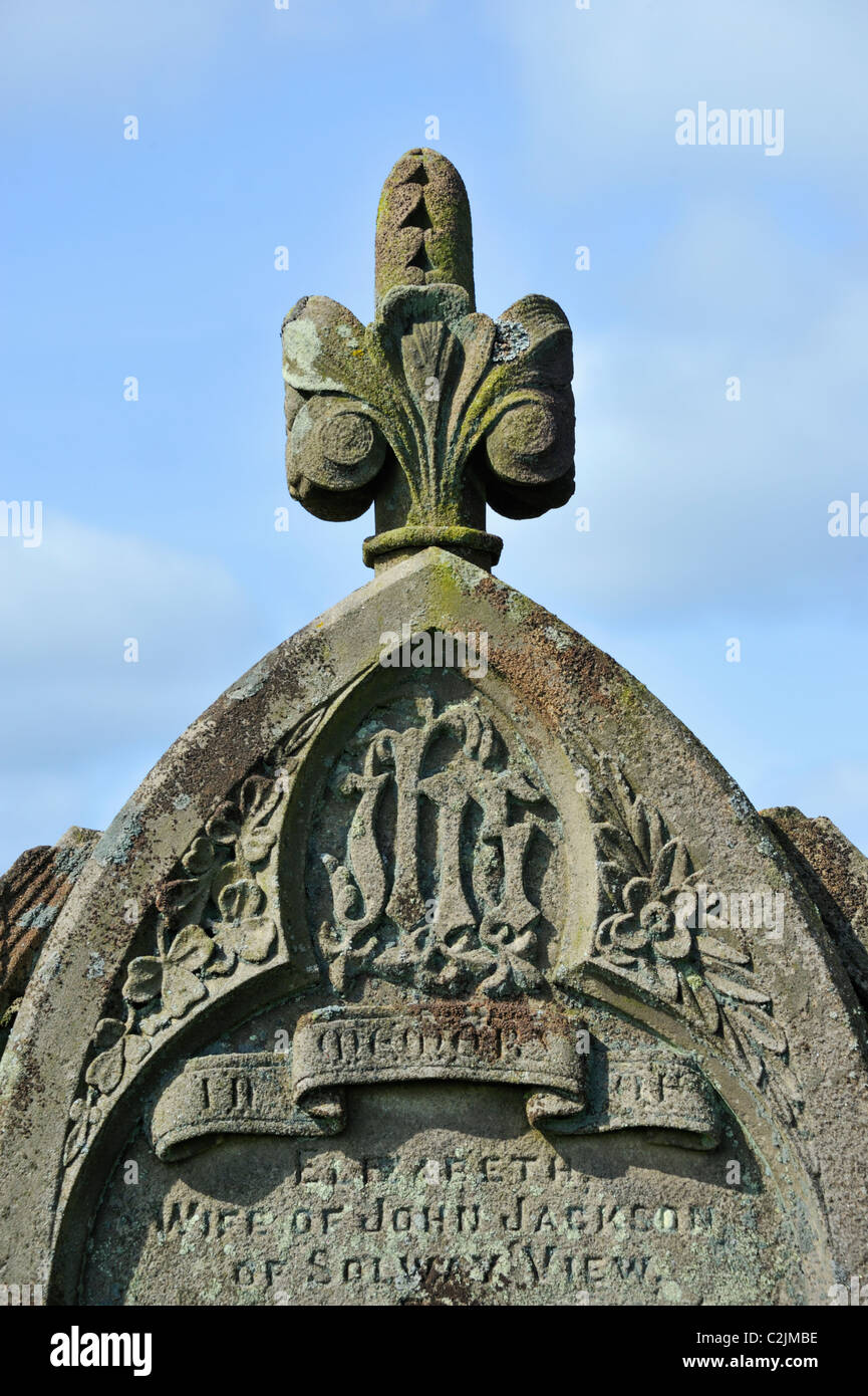 Detail of gravestone with IHS symbol. Church of Saint Cuthbert