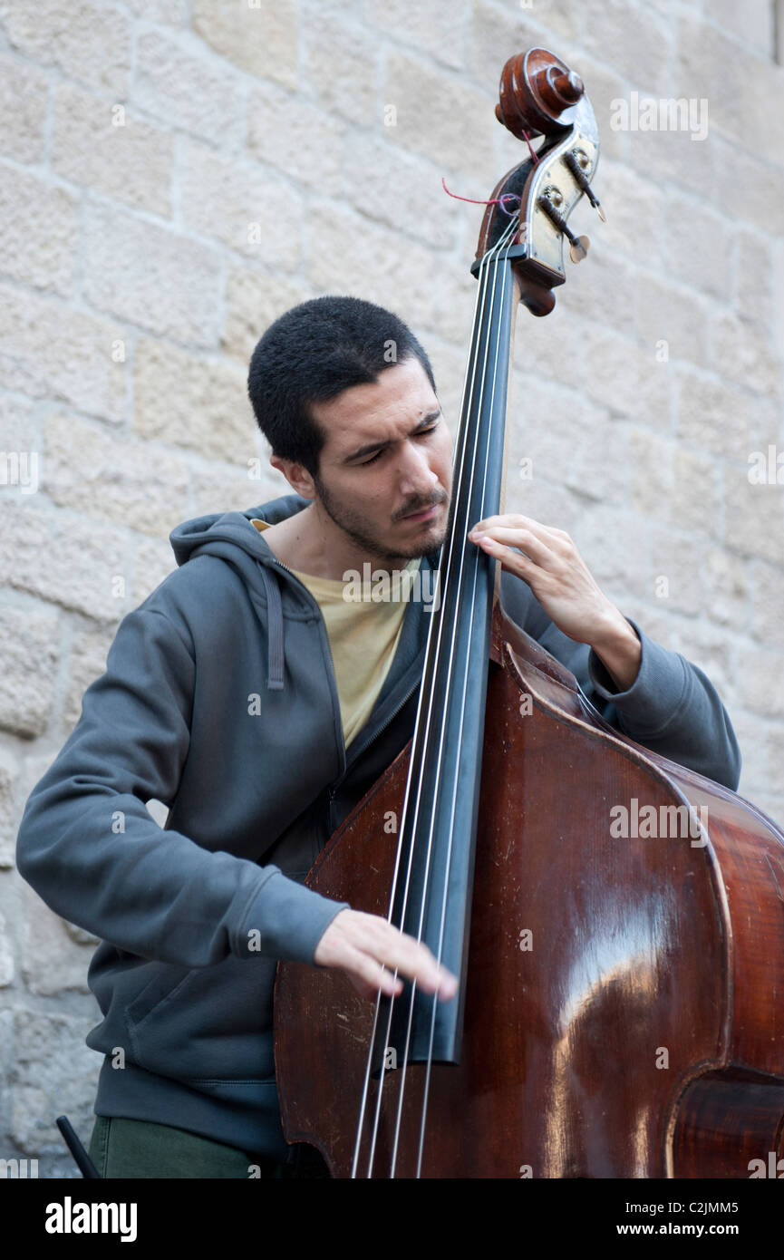 Double bass player performing in the gothic part of Barcelona, Spain