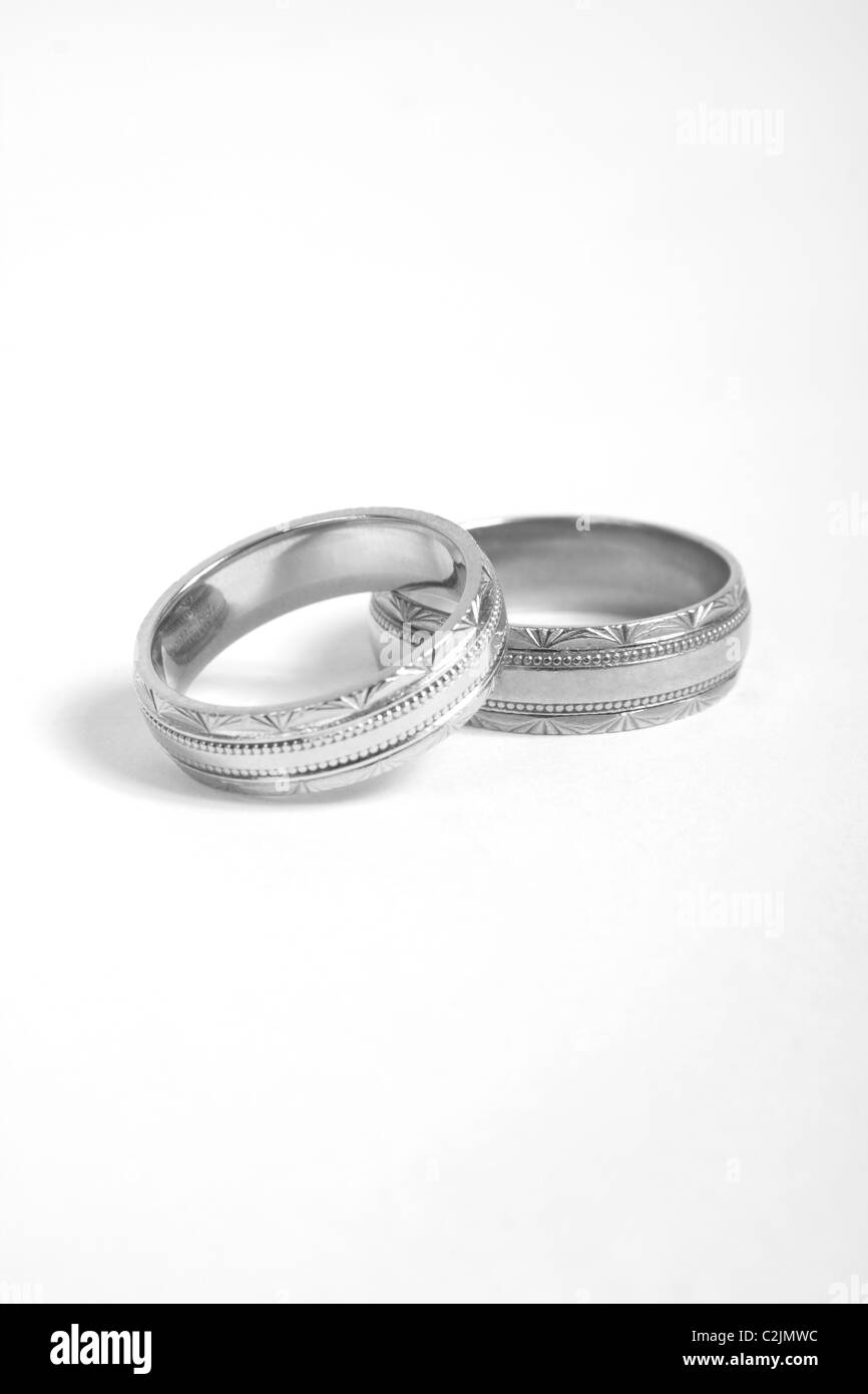 A pair of two wedding rings on a white background both gold and white