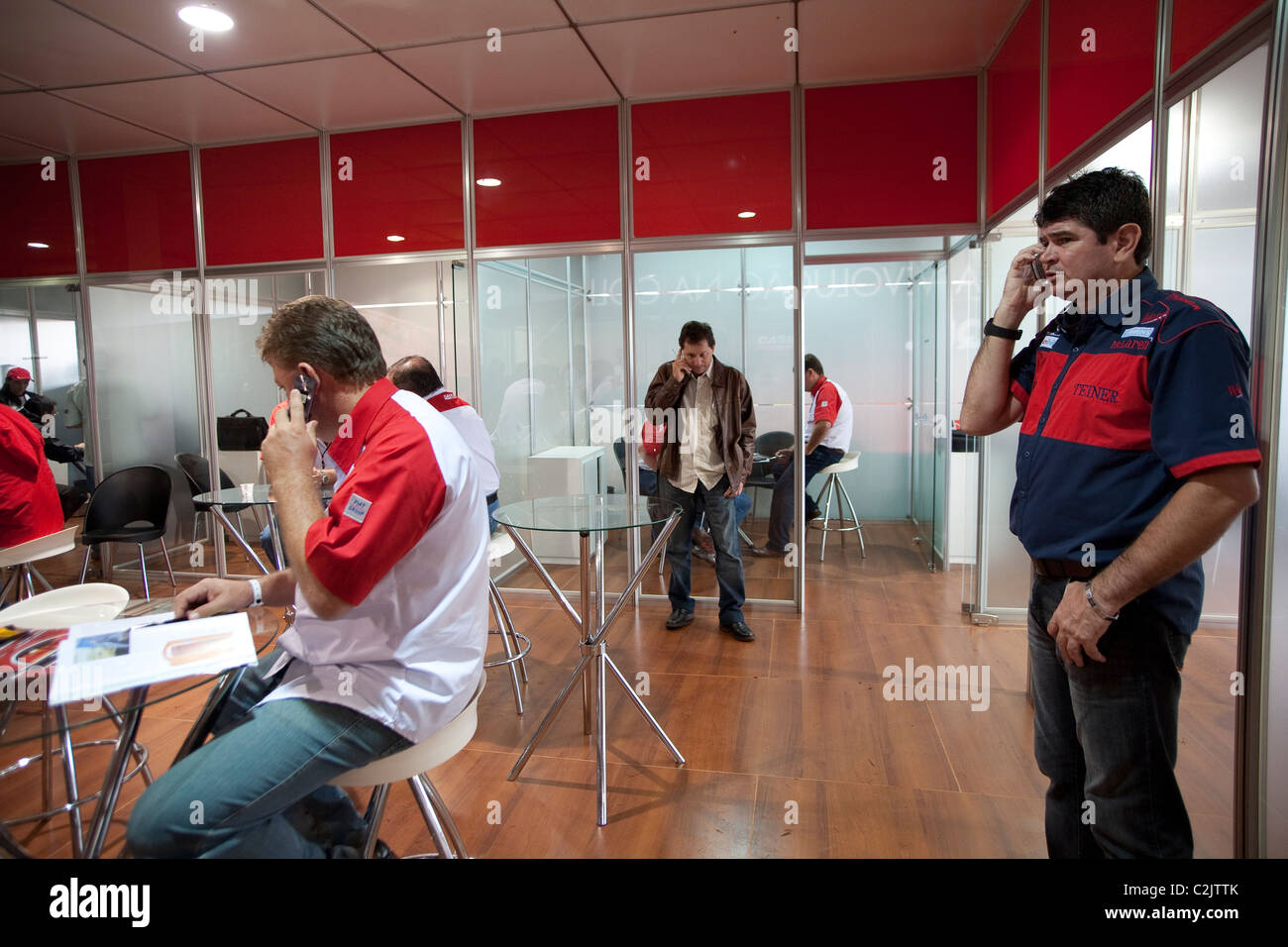 Salesmen on cell phone at Agrishow, the largest South America agribusiness trade fair, Ribeirao Preto, Sao Paulo State, Brazil Stock Photo