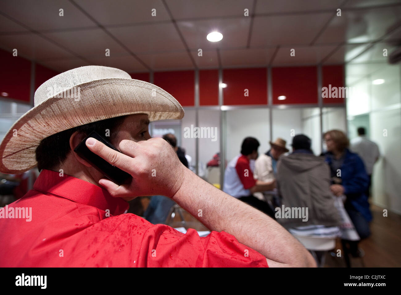 Salesmen on cell phone at Agrishow, the largest South America agribusiness trade fair, Ribeirao Preto, Sao Paulo State, Brazil Stock Photo