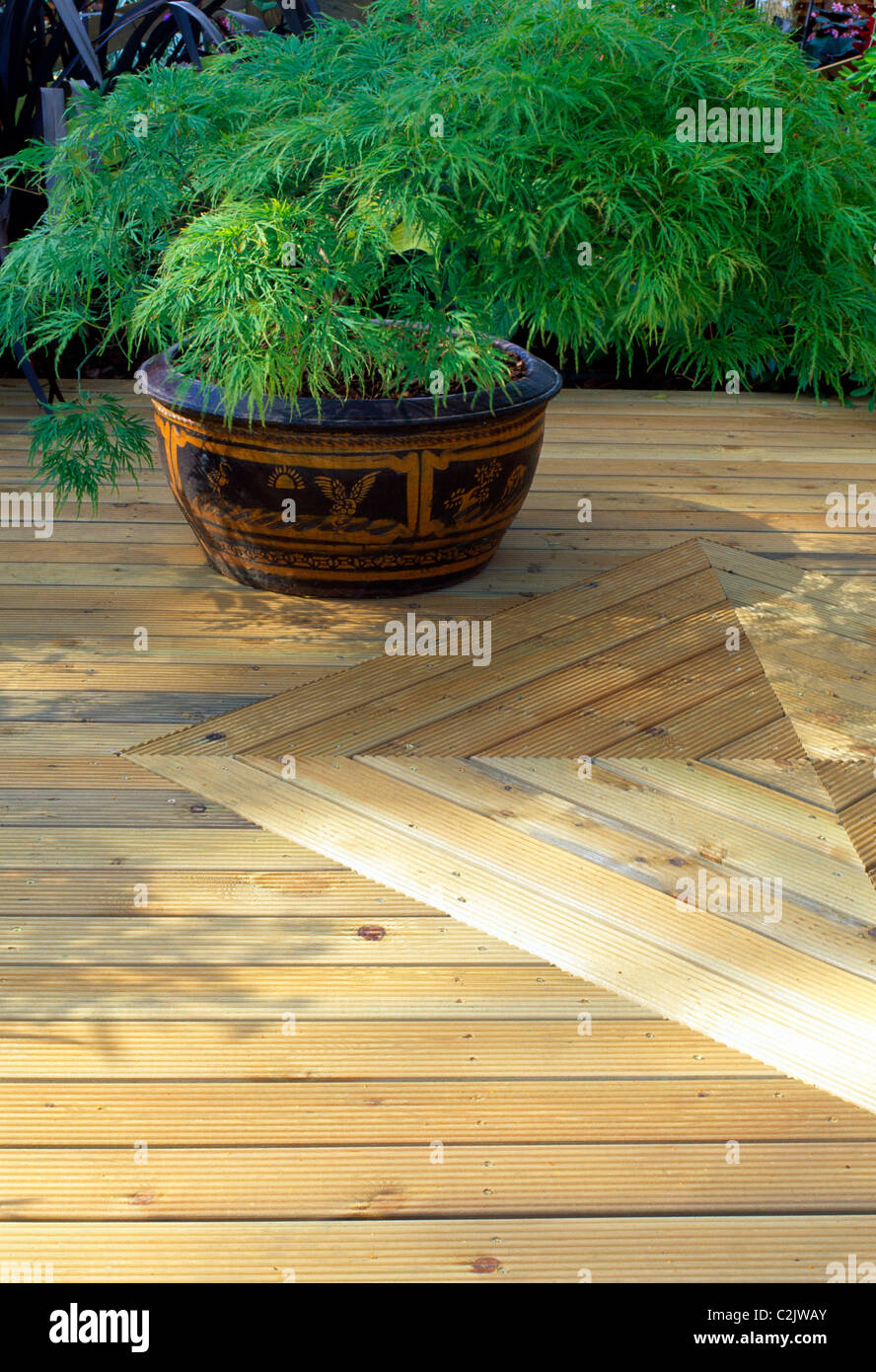 Decorative use of wooden deck in a garden Stock Photo