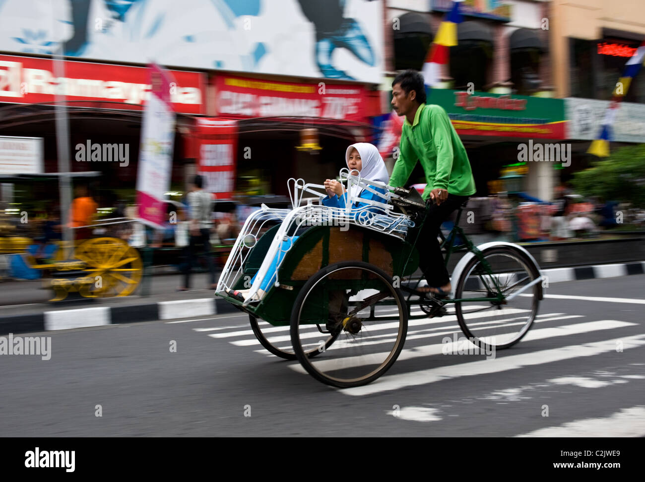 A Becak Trishaw Carries A Passenger Along Jalan Malioboro Central Yogyakarta Java Indonesia 