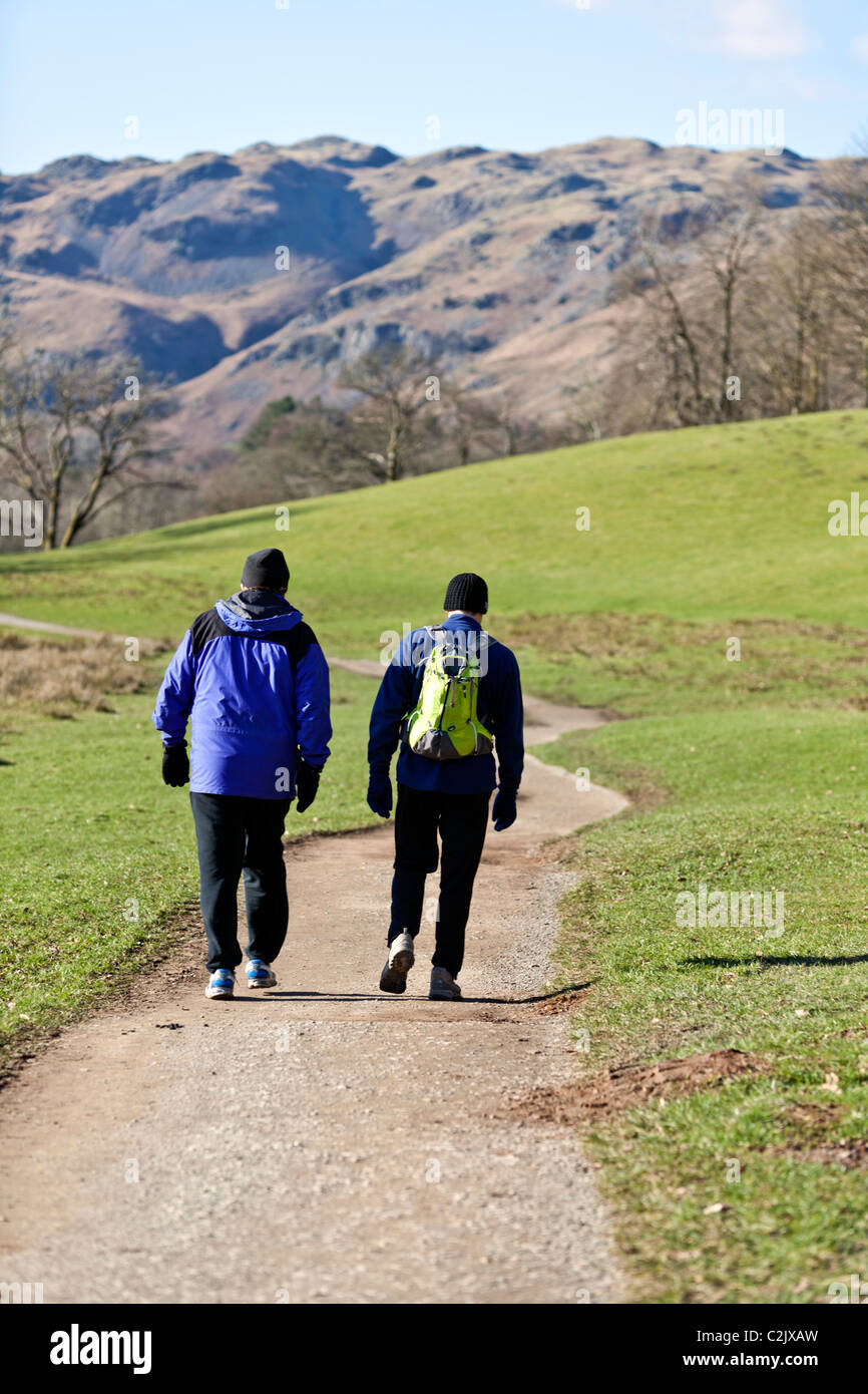 Walkers at Elter Water, The Lake District, Cumbria, England, UK. Stock Photo