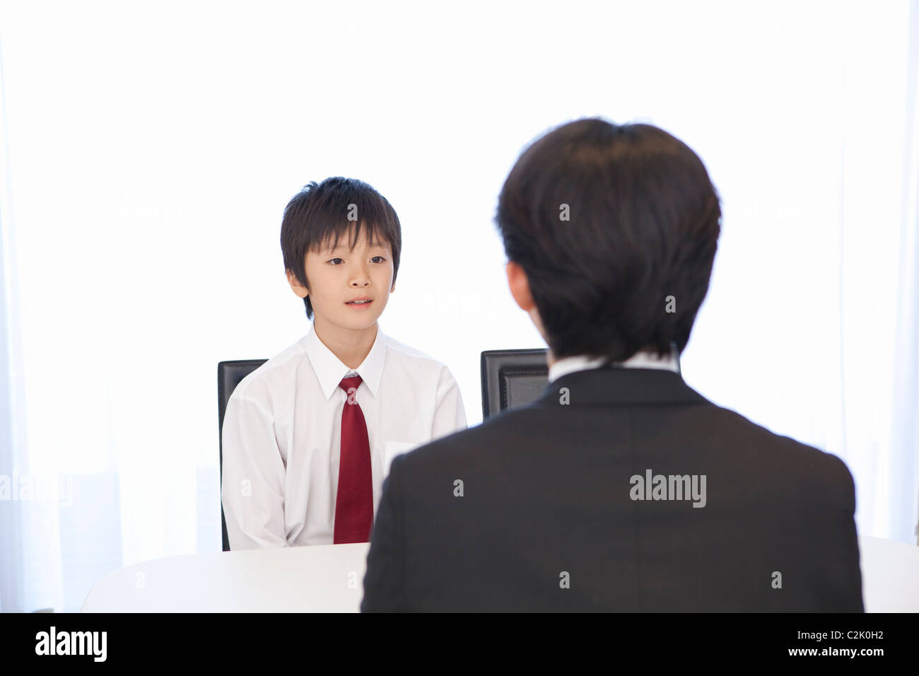 Junior High School Boy Talking to Teacher Stock Photo