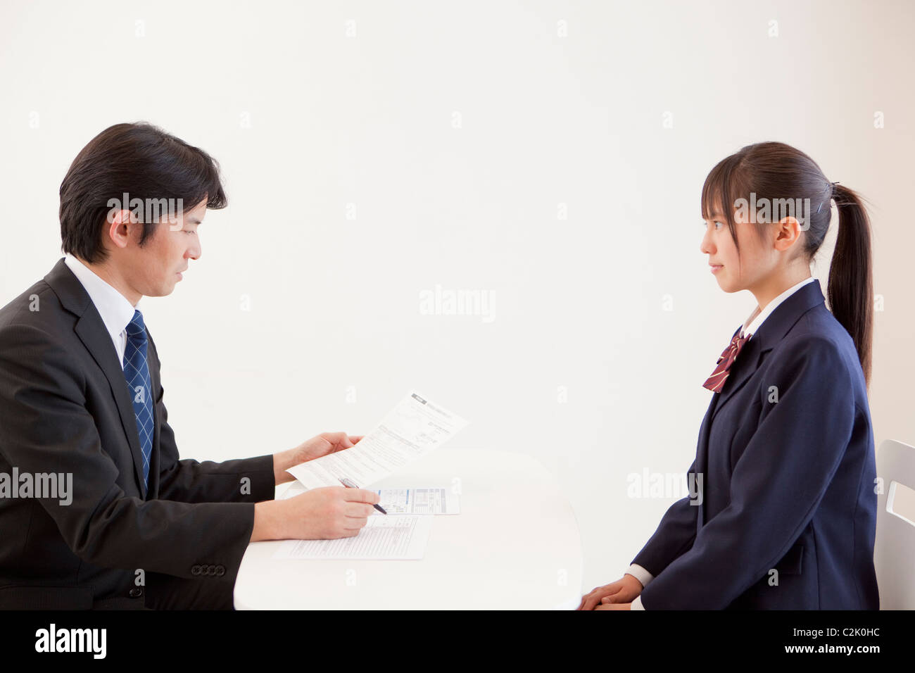 High School Girl and Teacher Having a Meeting Stock Photo - Alamy