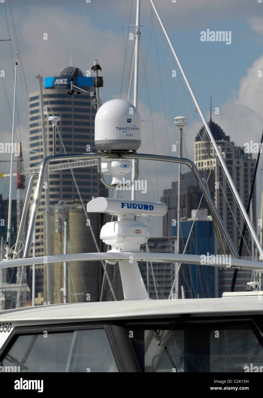 KVH Tracvision M3 marine satellite dome and Furuno open array radar on motor yacht masthead, Westhaven Marina, Auckland Stock Photo