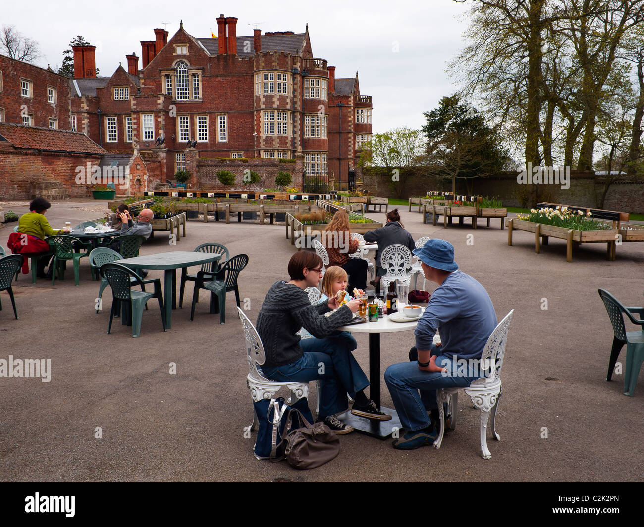 Visitors enjoying refreshments in the courtyard at Burton Agnes Hall East Yorkshire. Stock Photo