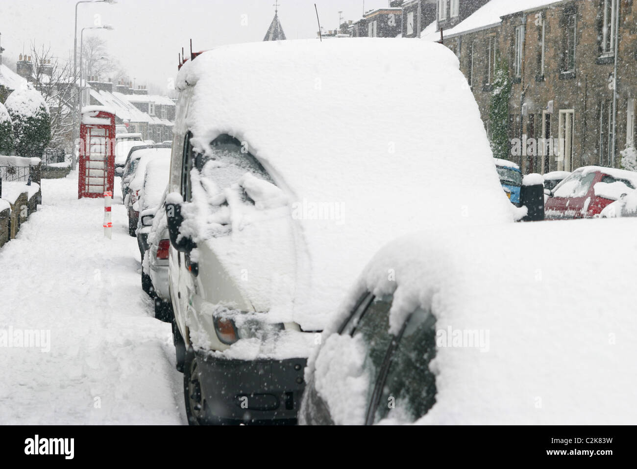 Parked cars in a street covered in snow Stock Photo - Alamy