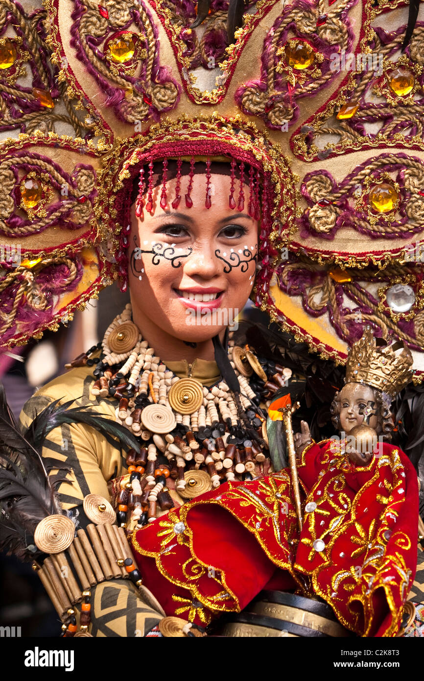 A portrait of a lady in beaded costume and beaded head dress holding a Sto. Nino statuette Stock Photo - Alamy A portrait of a lady in beaded costume and beaded head dress holding a Sto. Nino statuette Stock Photo - Alamy