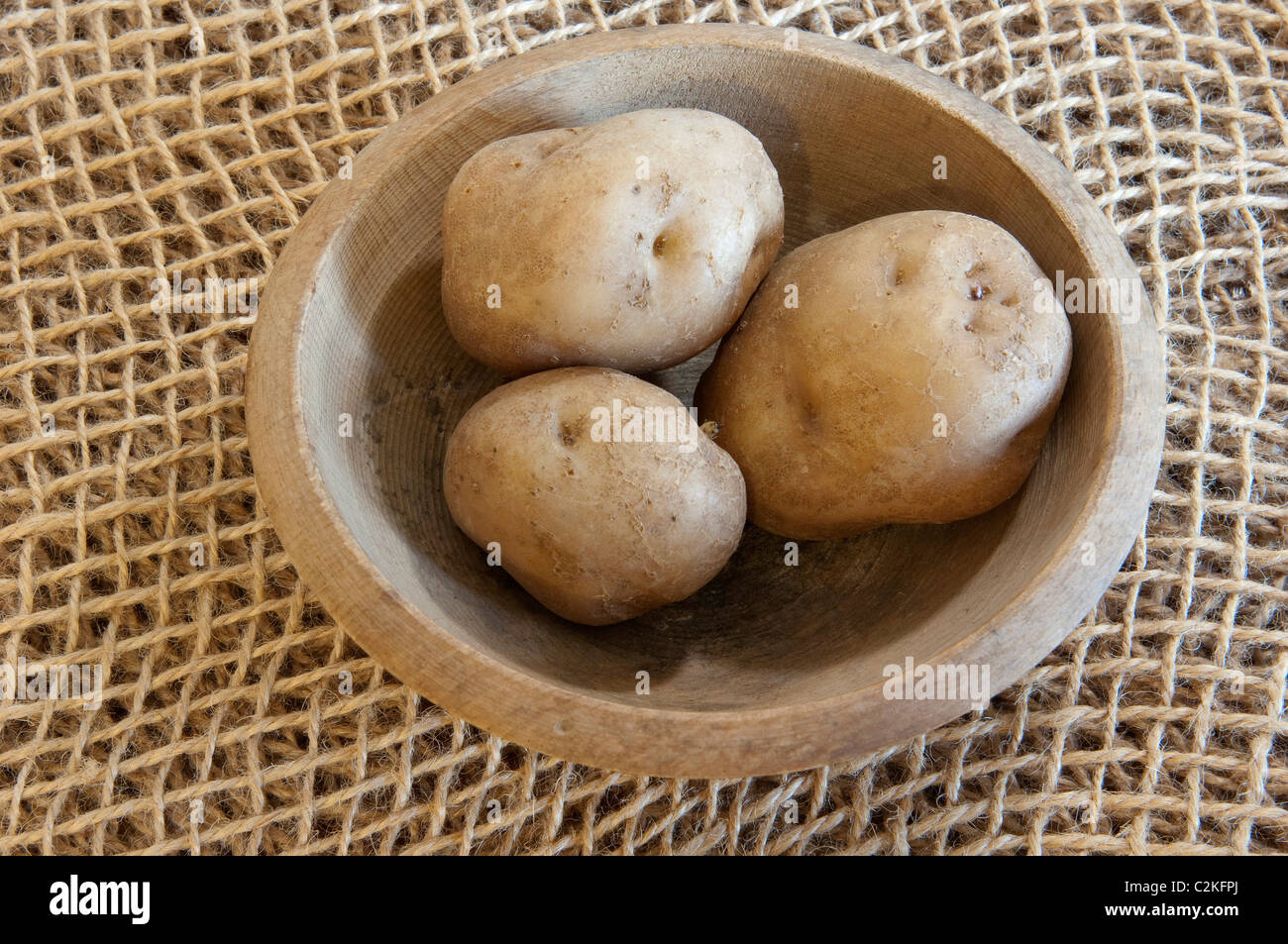 Potato (Solanum tuberosum), variety: Epicure. Potatoes a wooden bowl. Stock Photo