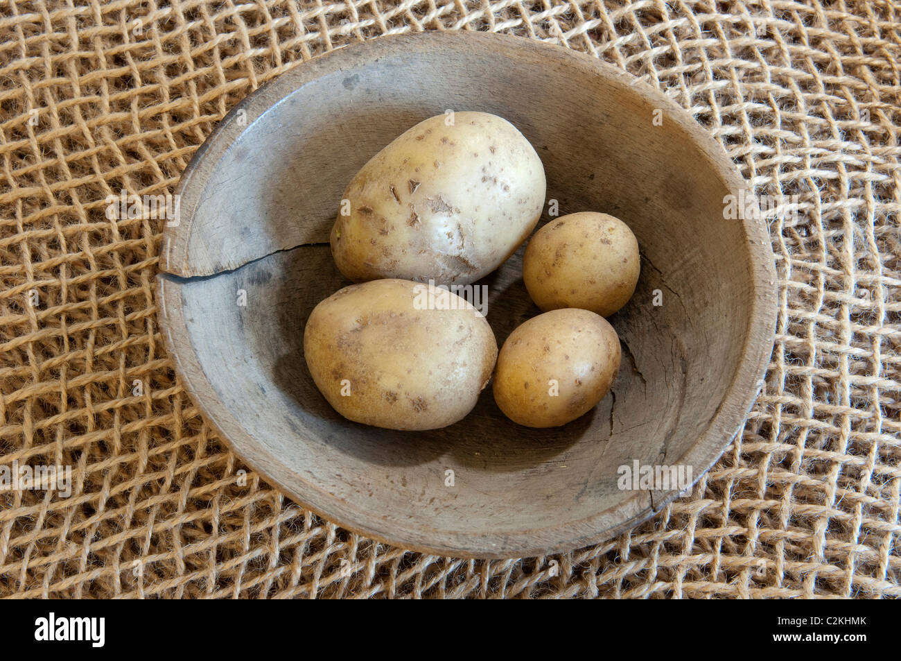 Potato (Solanum tuberosum), variety: Orla. Potatoes a wooden bowl. Stock Photo