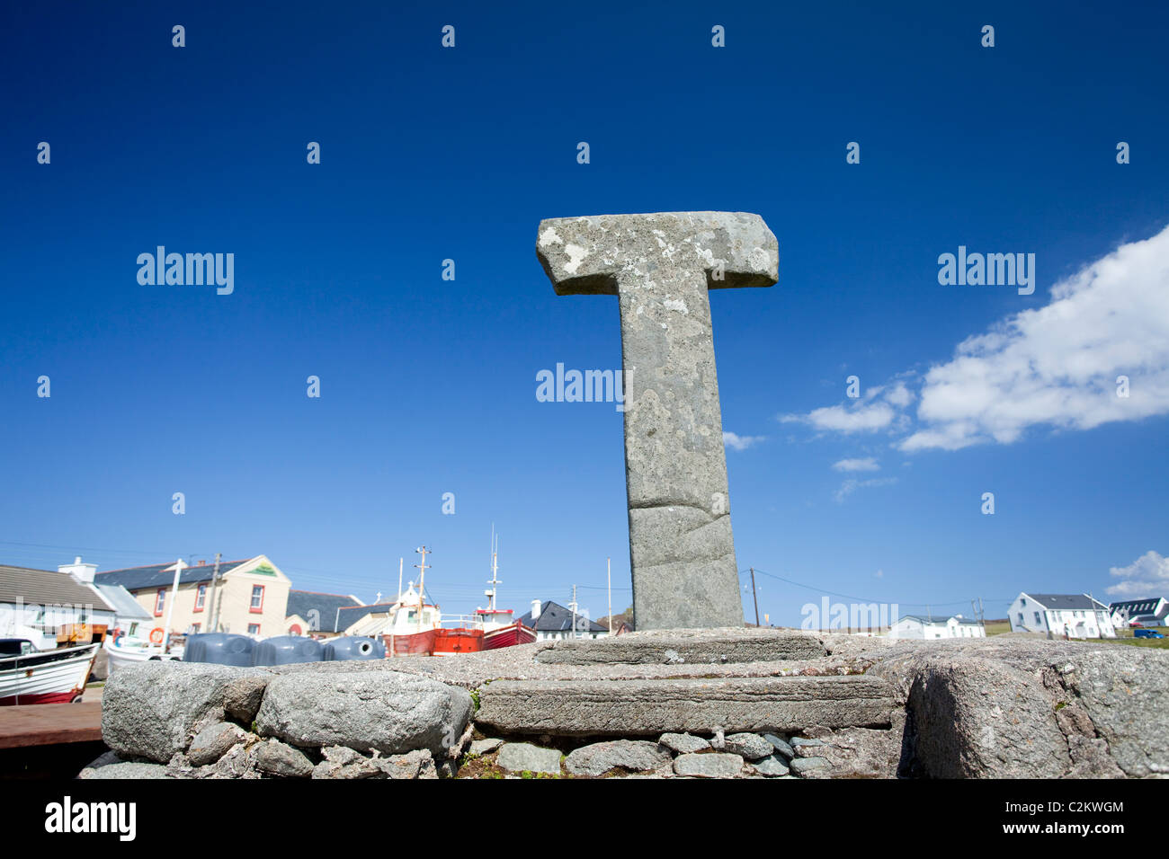 12th-century Tau Cross beside the harbour in West Town, Tory Island, County Donegal, Ireland. Stock Photo