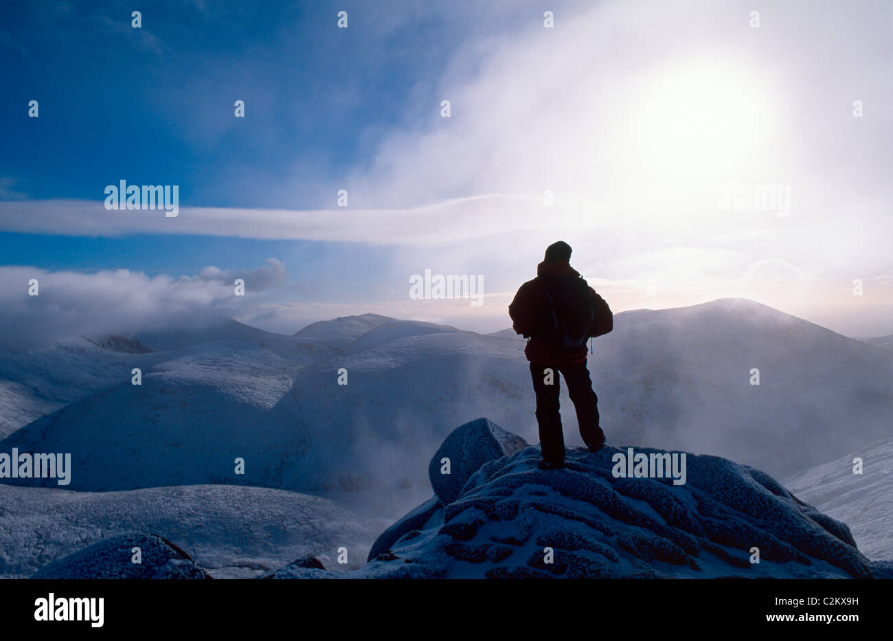 Winter walker at the summit of Slieve Bearnagh, Mourne Mountains, County Down, Northern Ireland. Stock Photo