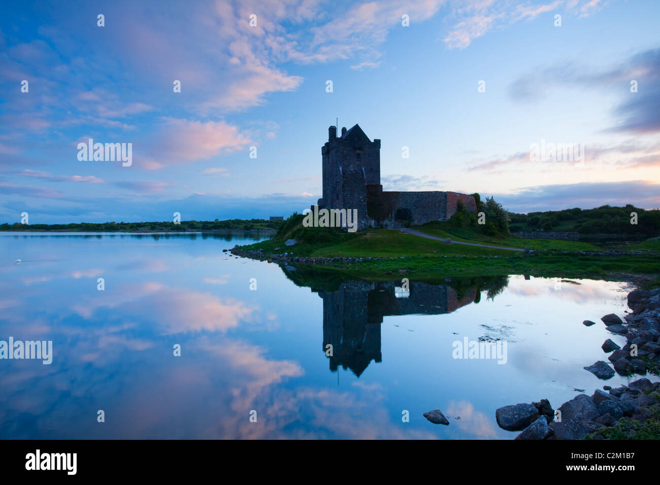 Sunset reflection of 16th-century Dunguaire Castle, Kinvara, Galway Bay, County Galway, Ireland. Stock Photo