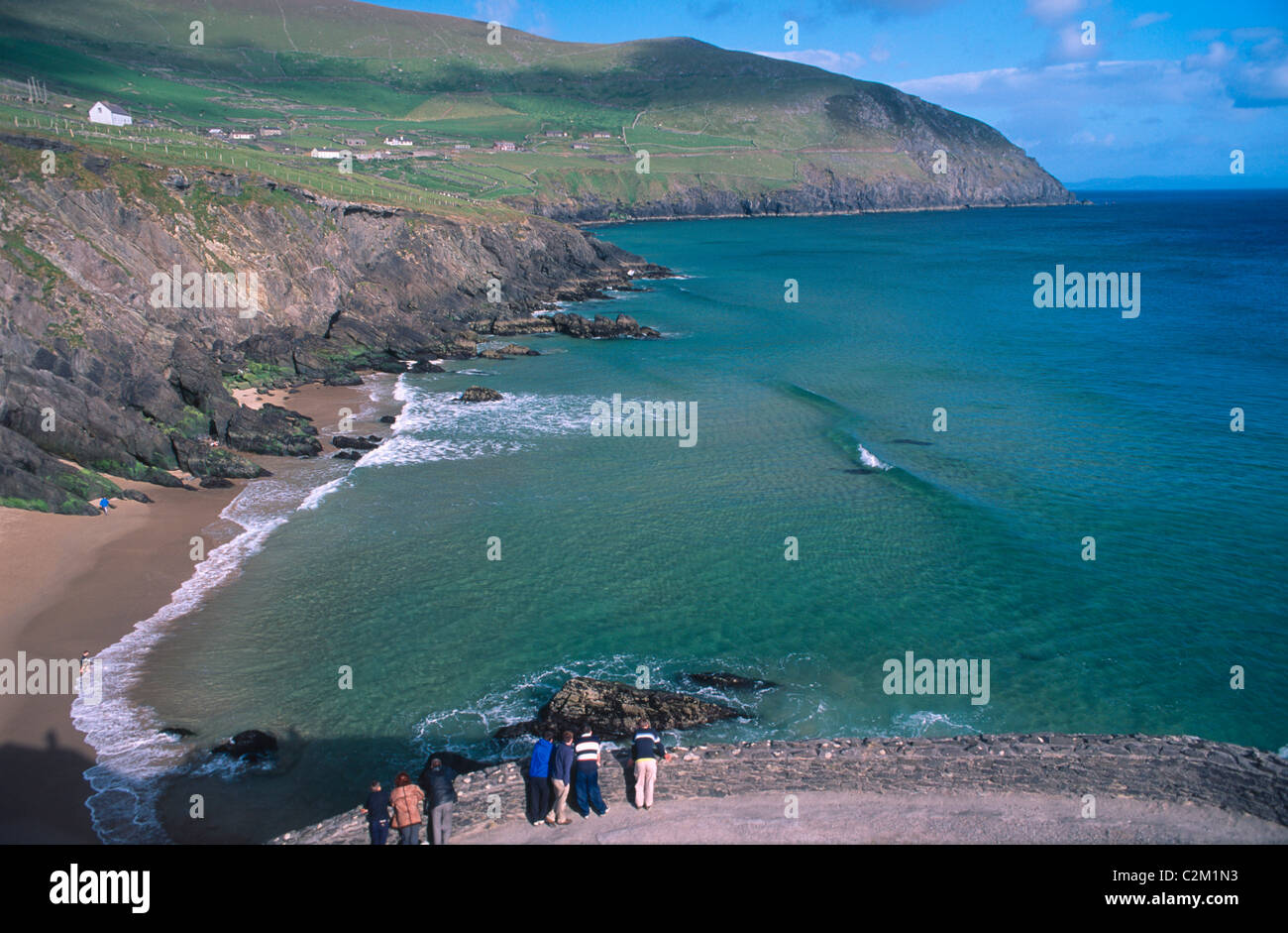 Visitors looking over Coumeenoole Bay from Slea Head, Dingle Peninsula, County Kerry, Ireland. Stock Photo