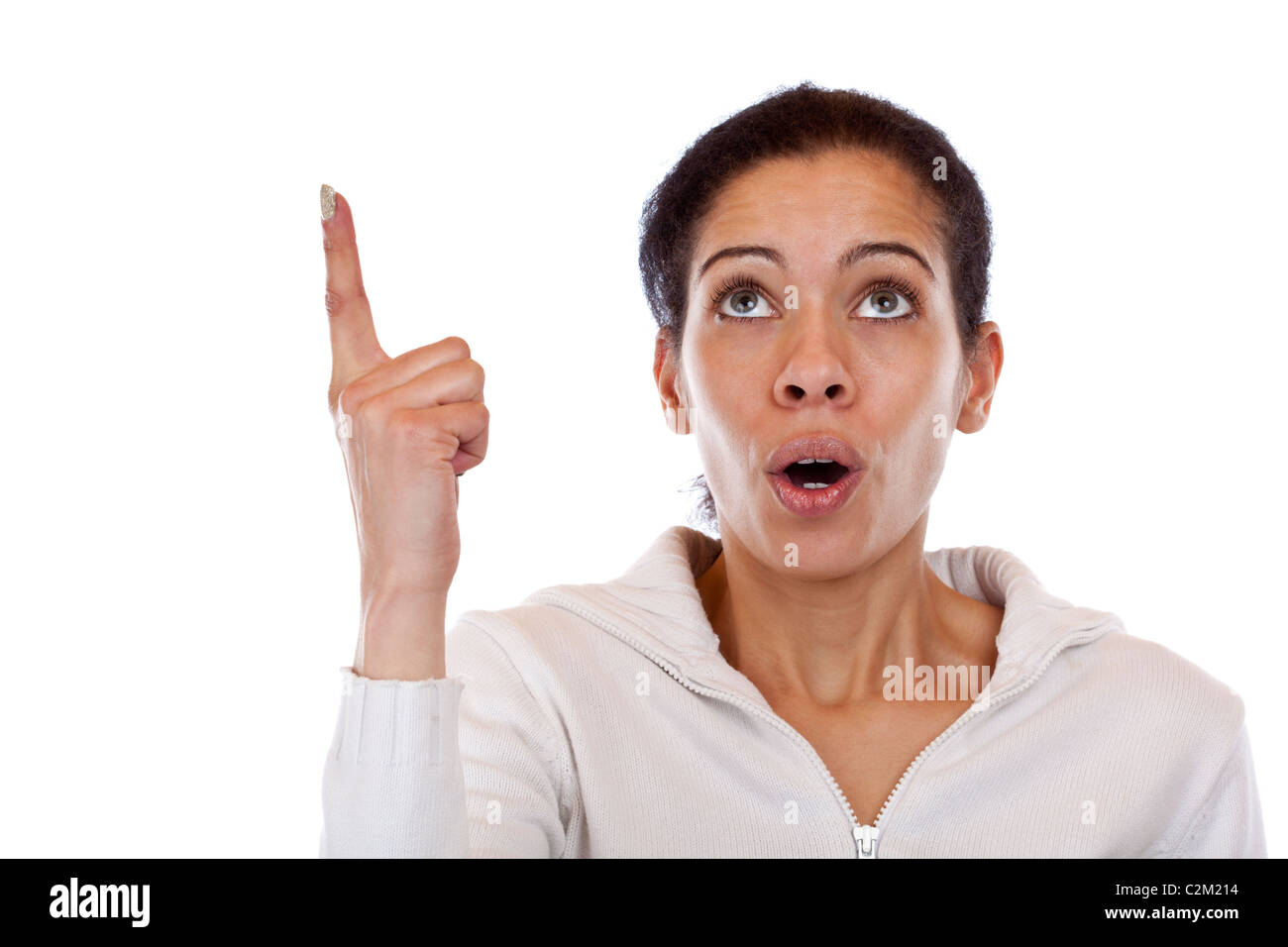 Attractive, black woman points with finger up to blank ad space. Isolated white background. Stock Photo