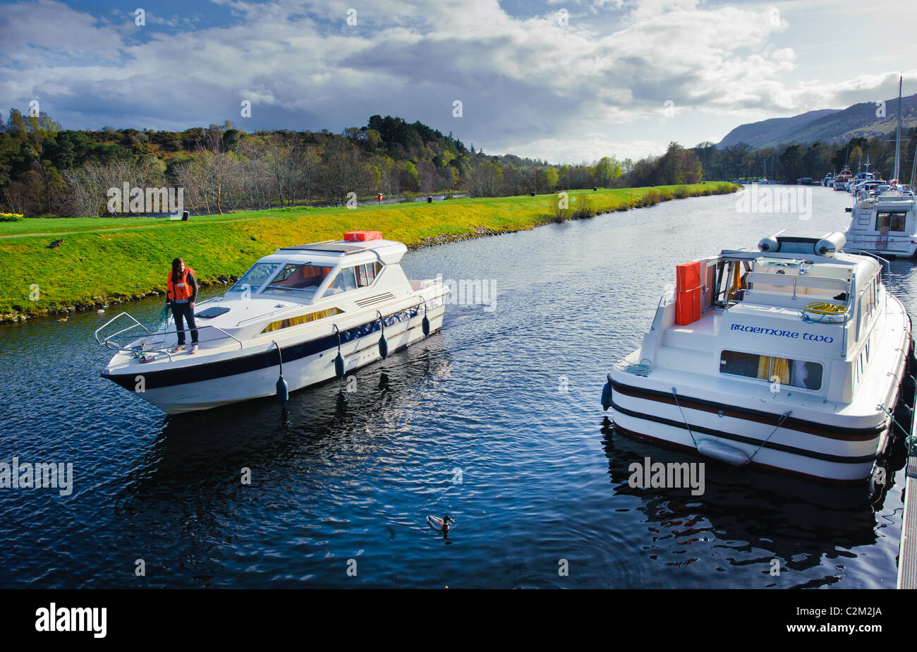 Cabin cruiser approaching it's mooring on the Caledonian Canal at Dochgarroch, Inverness-shire. Stock Photo