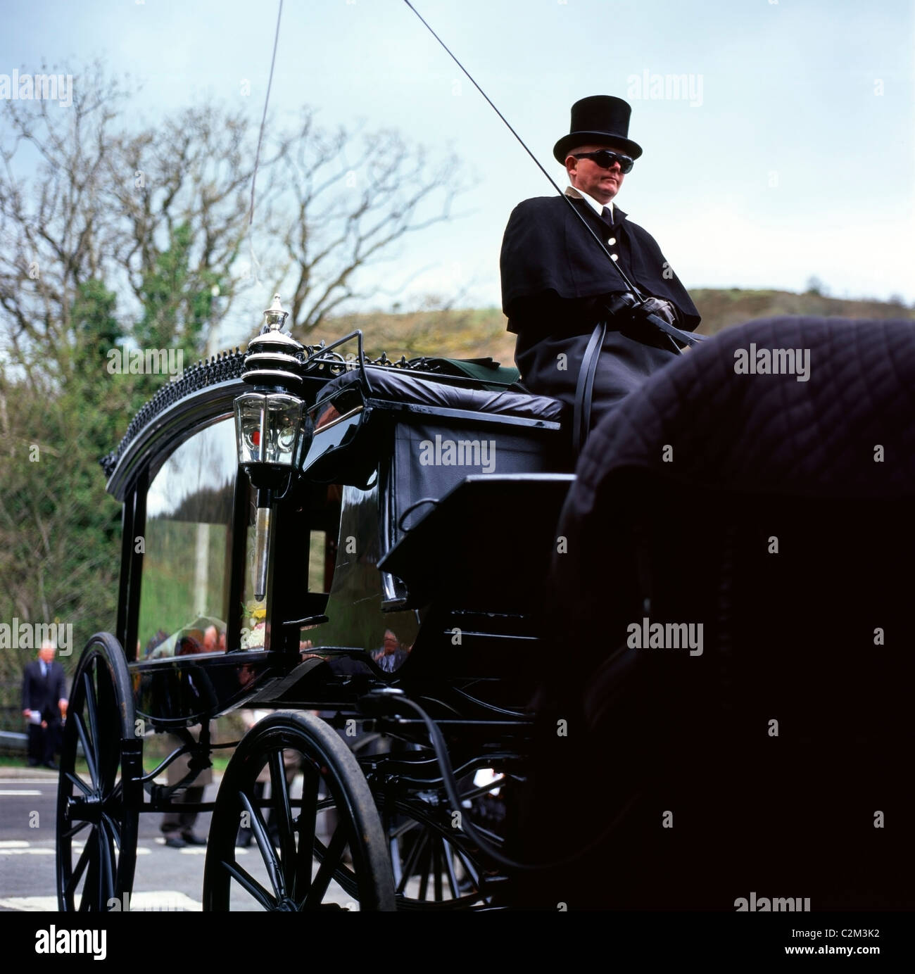 Coach driver of a horse-drawn carriage hearse waiting outside the chapel at a Welsh farmers funeral Wales Great Britain UK KATHY DEWITT Stock Photo