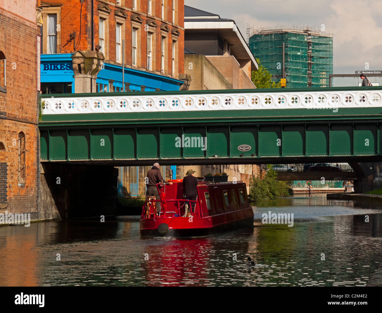 Barge passing under a bridge in Nottingham city centre canal England UK Stock Photo