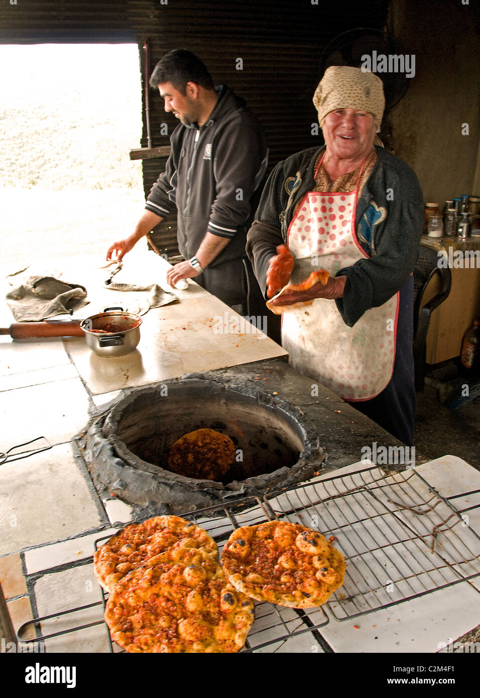 Bakery pancake pancakes pizza Syria desert Badiyat al Sham Bedouin Bedouins Villages woman Syrian Middle East Stock Photo