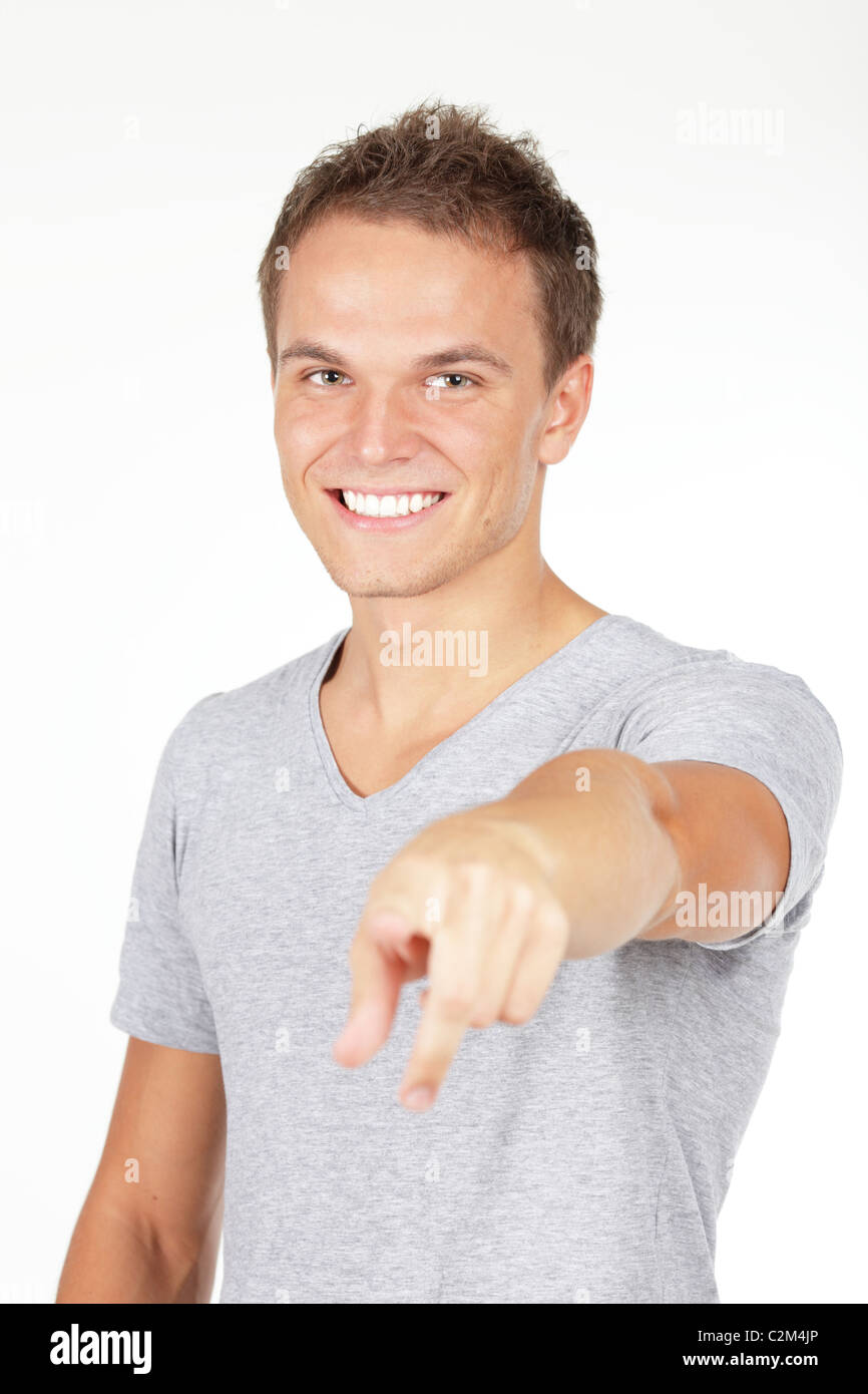 Point At Me Portrait of a young man smiling, pointing at you. Studio shot. Isolated ...