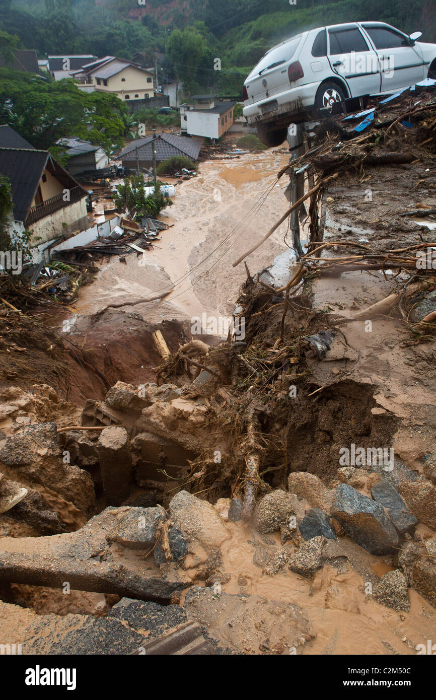 January 2011 Nova Friburgo flooding, Rio de Janeiro State, Brazil Car suspended on a house ruins A mud sea below it Stock Photo