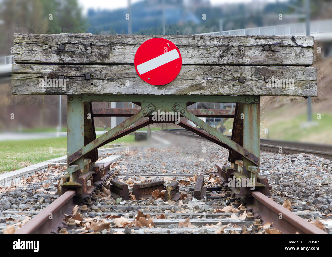 wooden buffer stop with red stop sign ending rail tracks concept for limit, limitation restriction boundary, prohibited, end , Stock Photo