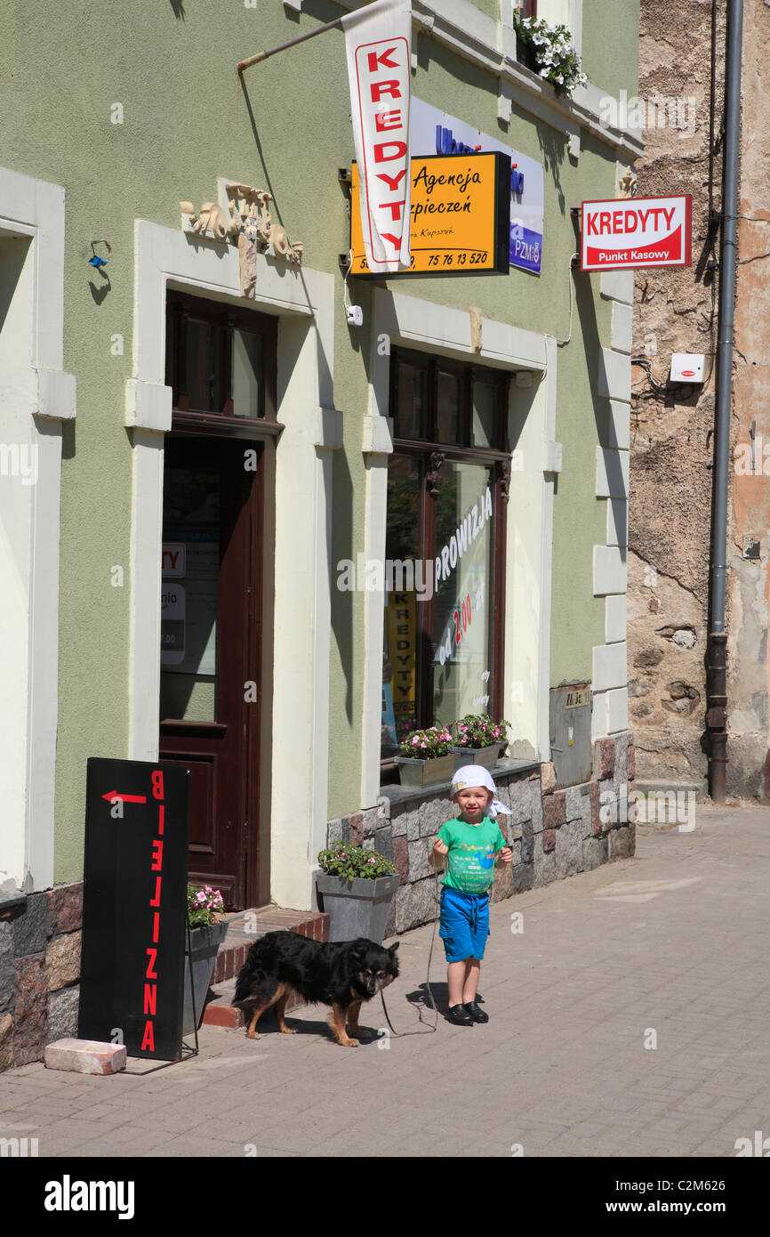 kid with dog infront of shop in mall kowary former german city schmiedeberg. poland, lower silesia, europe Stock Photo