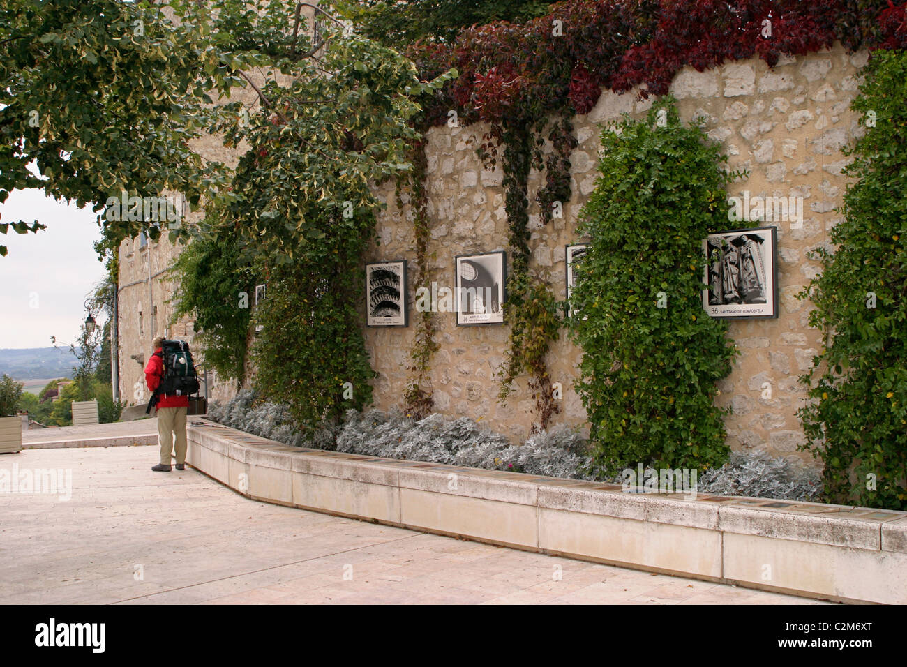 a pilgrim with conch shell on rucksack in the pilgrims garden France