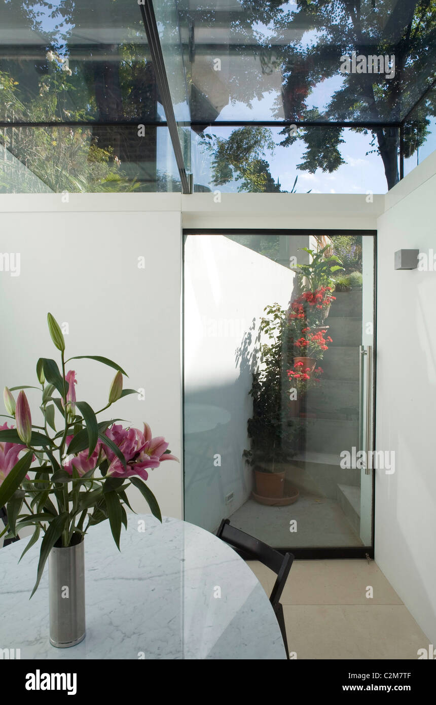 Glass extension, dining table and rear entrance. Living etc. publishing this image May Stock Photo