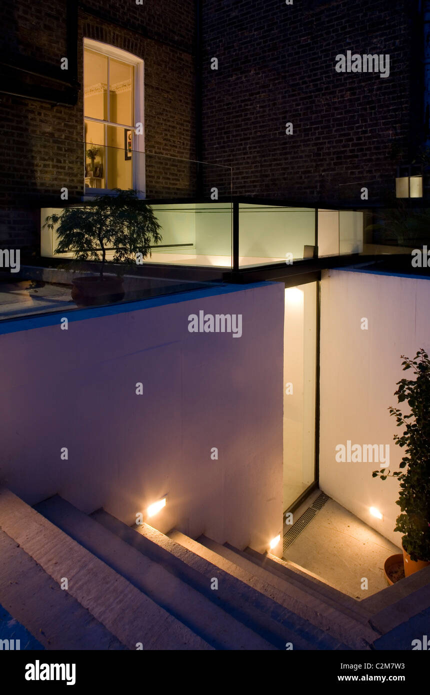 Glass extension, rear entrance at dusk. Stock Photo