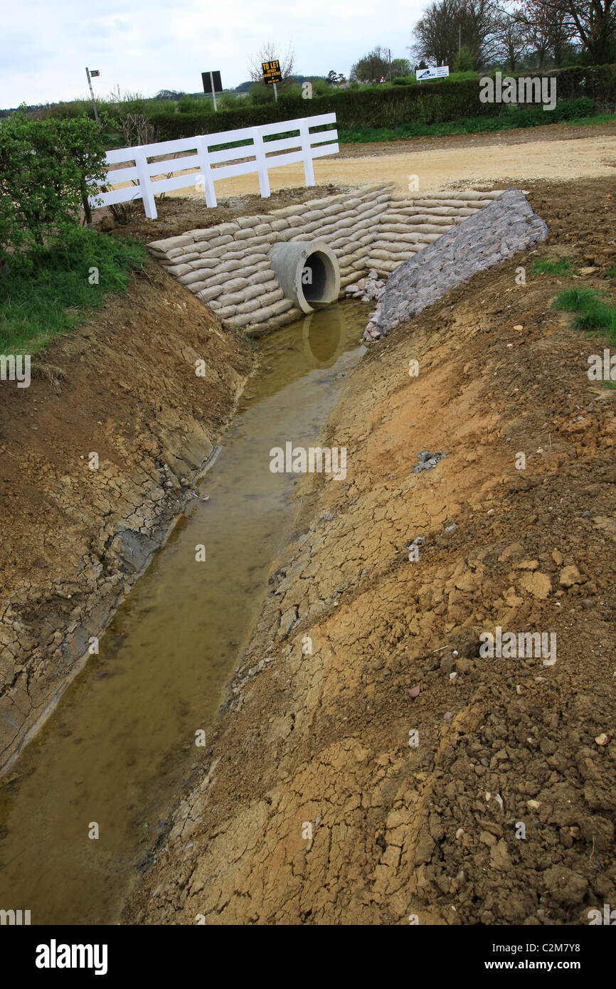 Culvert, channel water, underneath road, railway, embankment, drainage, running water, flooding, projects, land, works, tunnel, flood prevention, silt Stock Photo