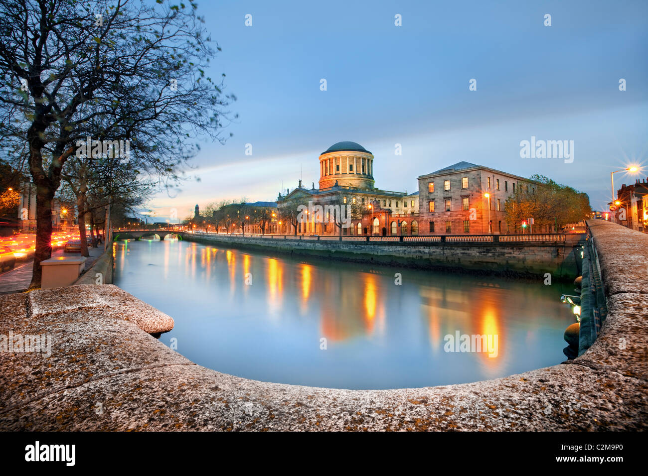 A view along the river Liffey Dublin at dusk with the Four Courts featuring prominently Stock Photo