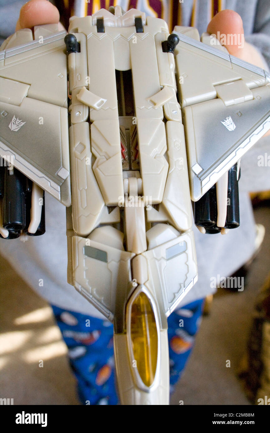 Boy age 8 holding his Star Wars ship plane. Clitherall Minnesota MN USA Stock Photo