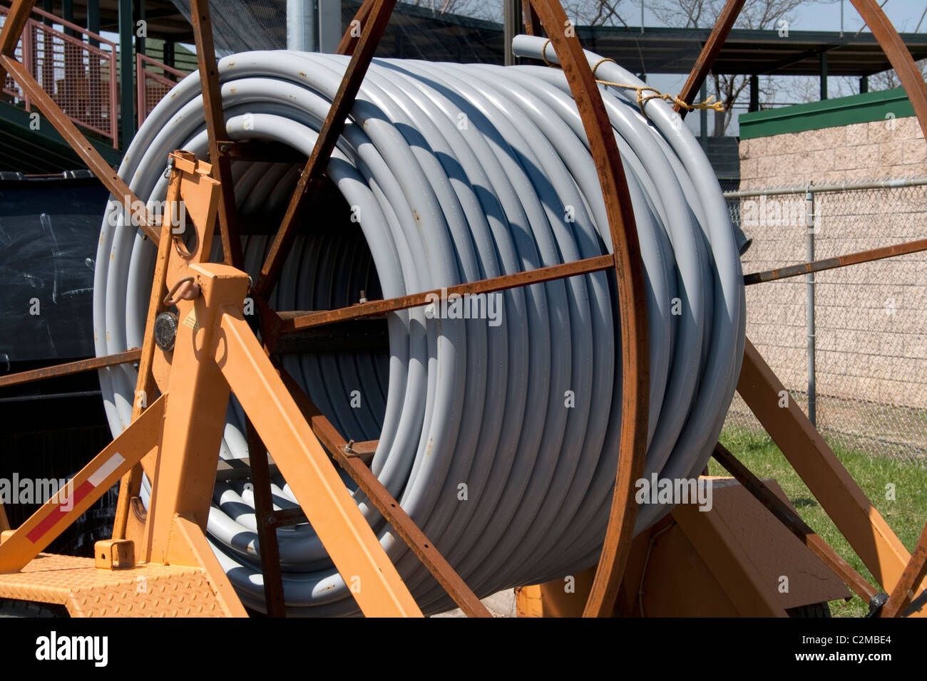 Large reel of gray plastic pipe at construction site. St Paul Minnesota