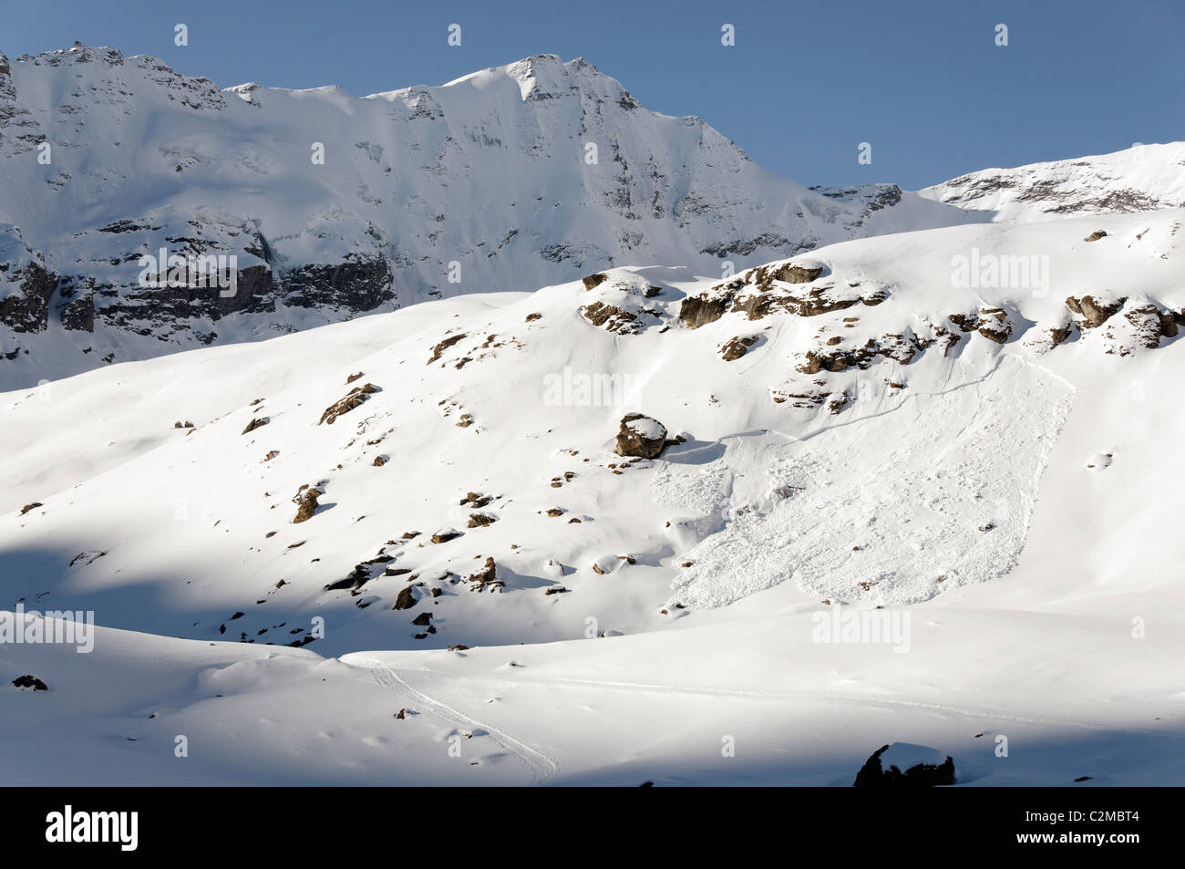 An area of windslab avalanche on a shallow snowpack, Switzerland. Stock Photo