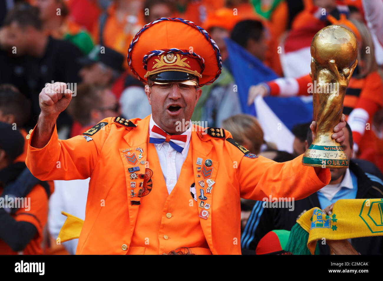 A Holland supporter cheers while holding a replica trophy at a 2010 World Cup football match between the Netherlands and Denmark Stock Photo
