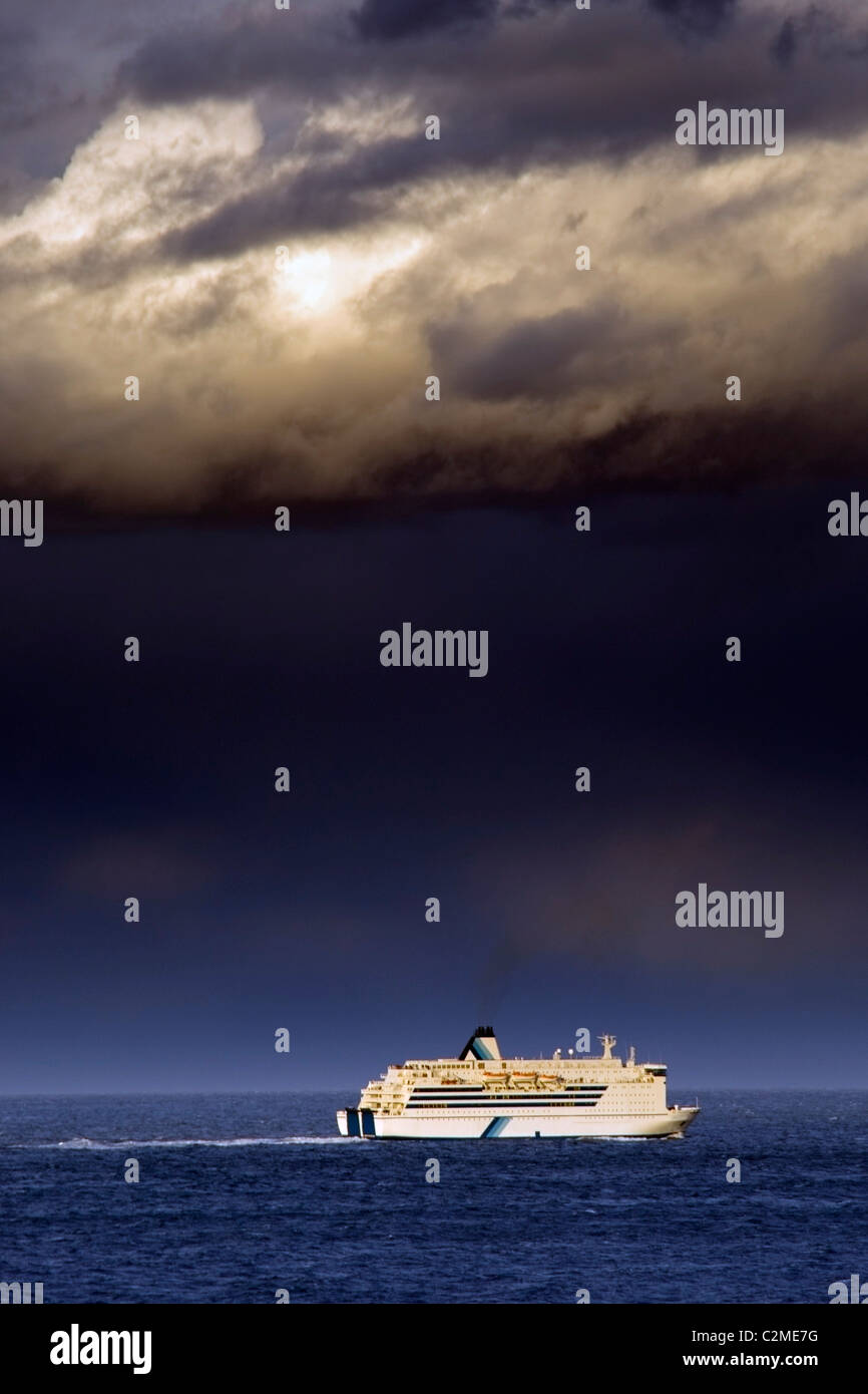 Cruise Ship Under A Dark Cloud Stock Photo - Alamy