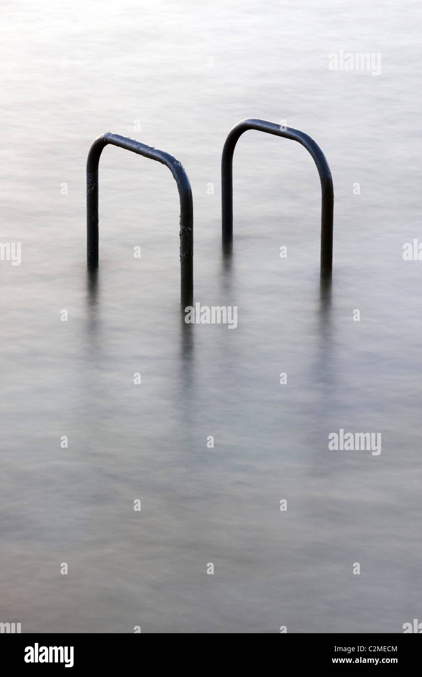 Hand rails at a tidal swimming pool in St Peters Port, Guernsey, The Channel Islands, UK Stock Photo