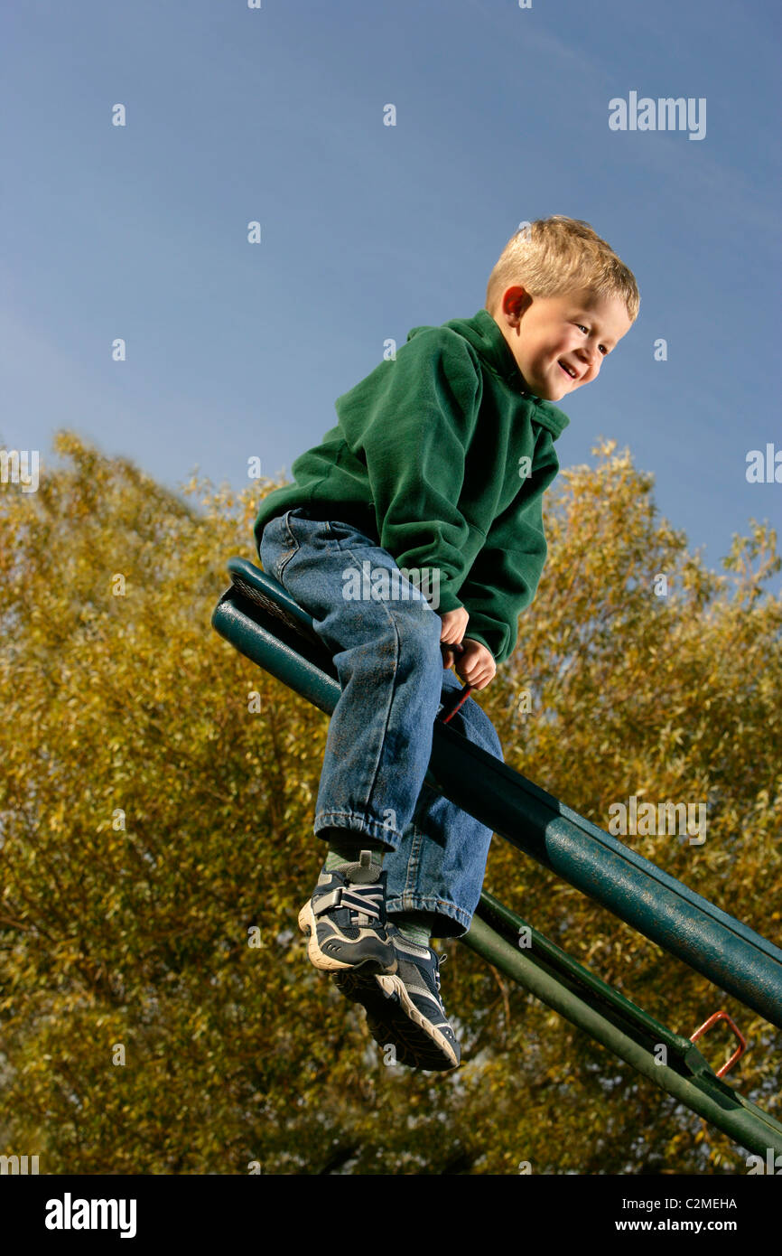 Boy Having Fun On A Seesaw Stock Photo