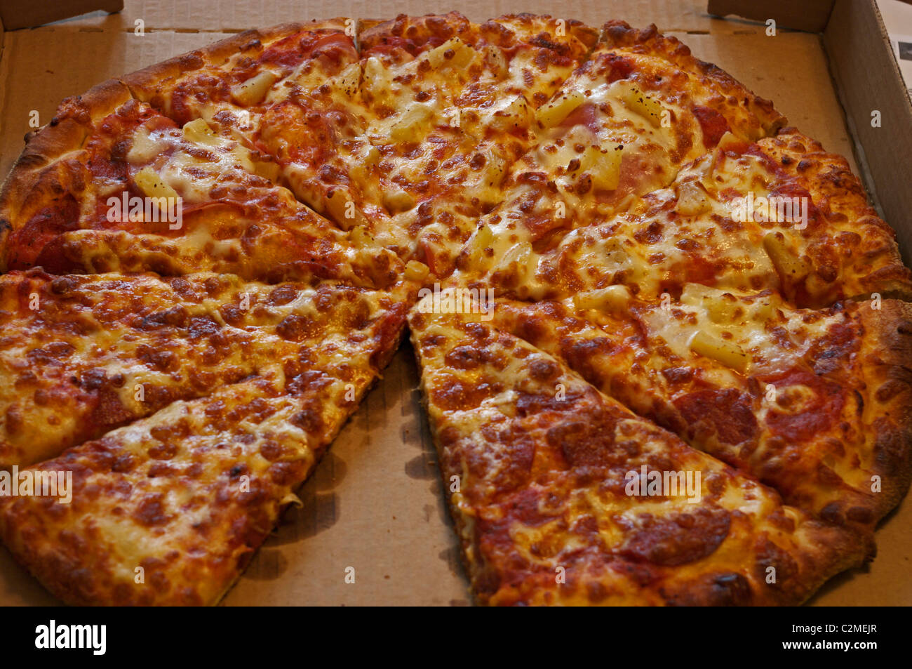 pepperoni and ham and pineapple pizza in box Stock Photo Alamy