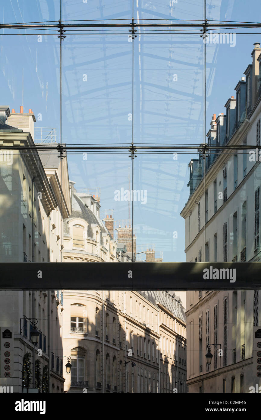 Traditional Paris apartment buildings and reflection of modern glass roof in Paris, France. Looking down Passage des Jacobins Stock Photo