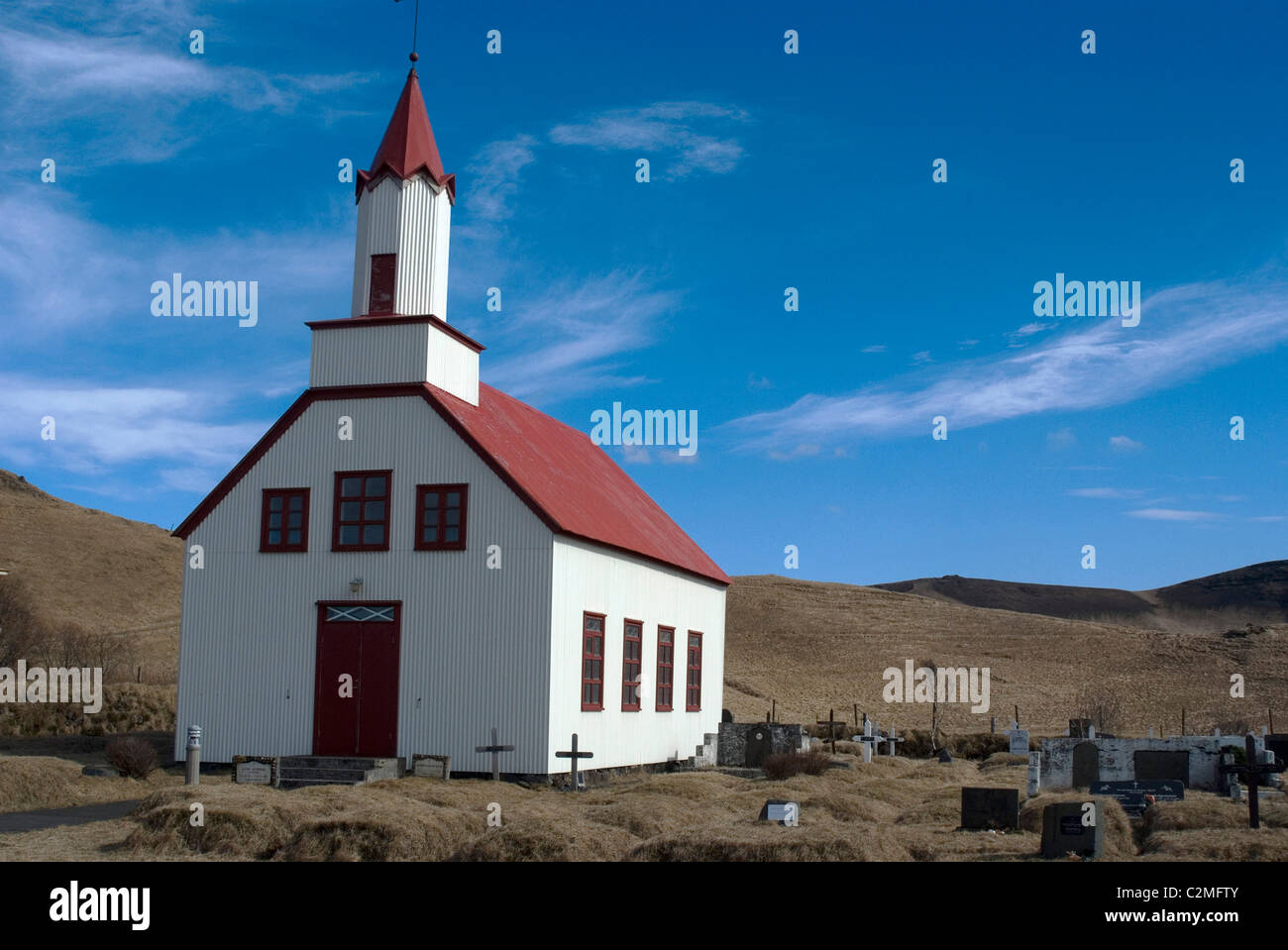 Traditional church and cemetery, near Dyrholaey (cliff side promontory and volcanic black sand beach), Southern Iceland Stock Photo