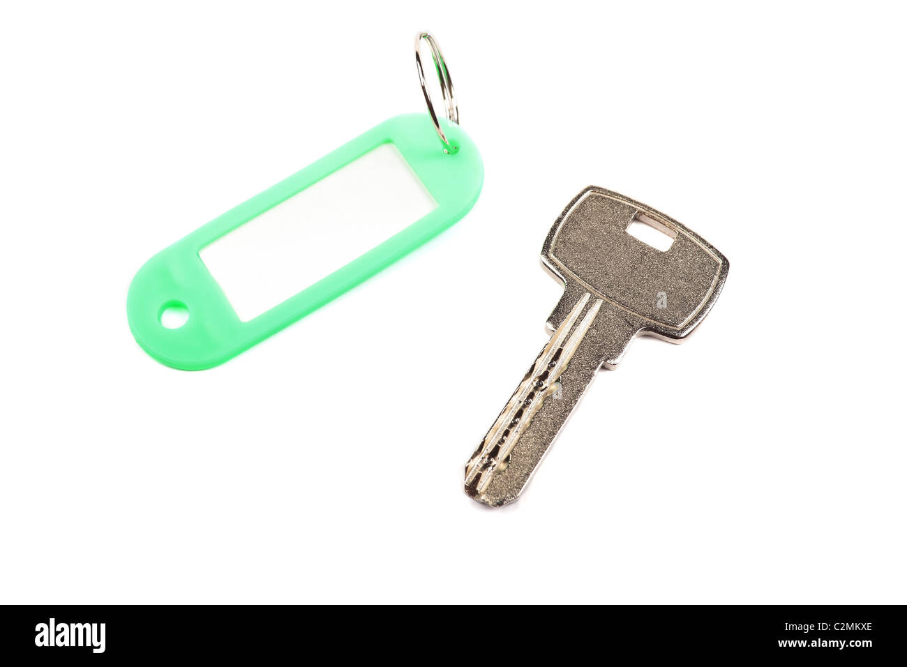 Key and green trinket with empty for your design space isolated on white background. Stock Photo