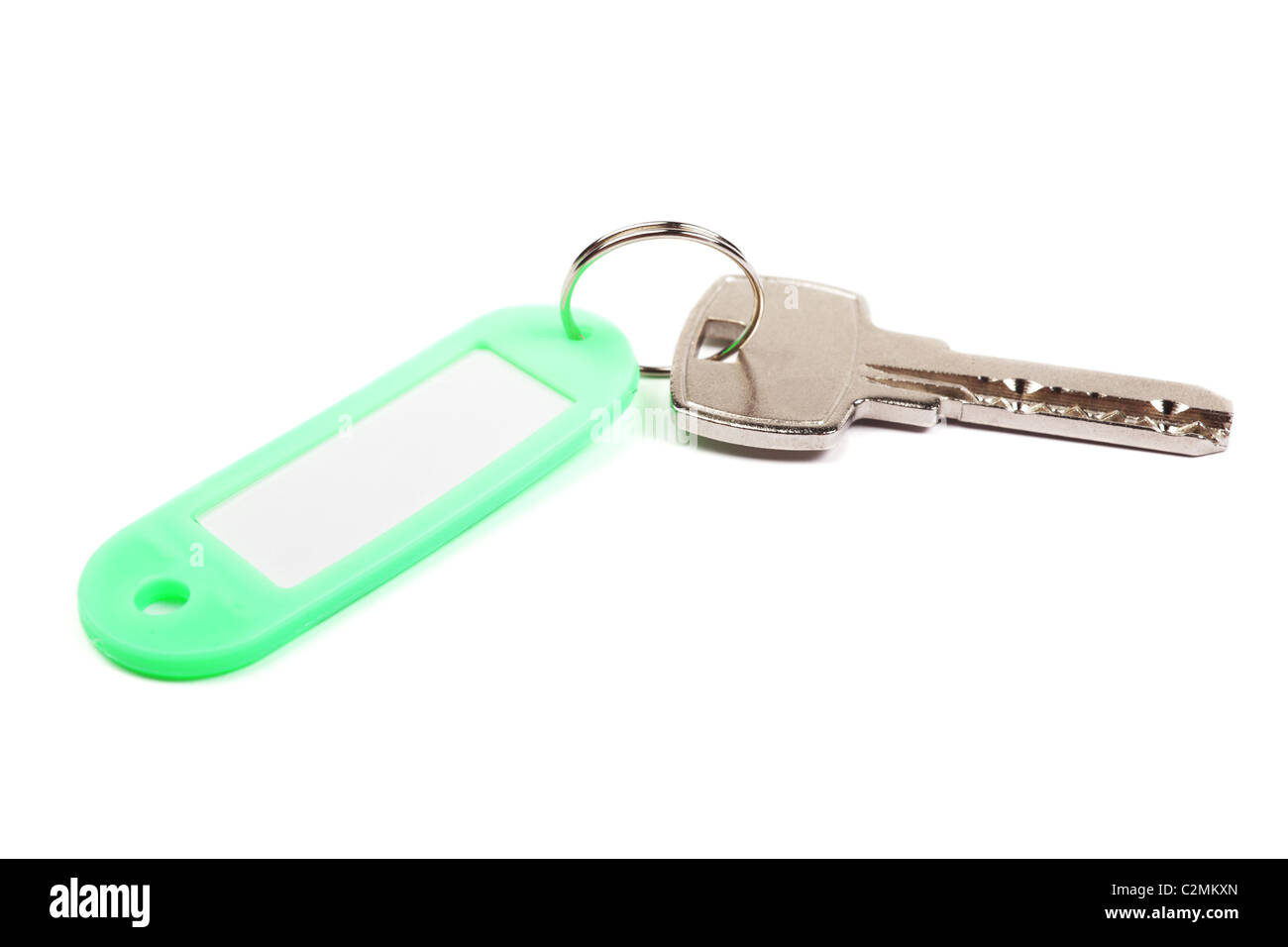 Key and green trinket with empty for your design space isolated on white background. Stock Photo