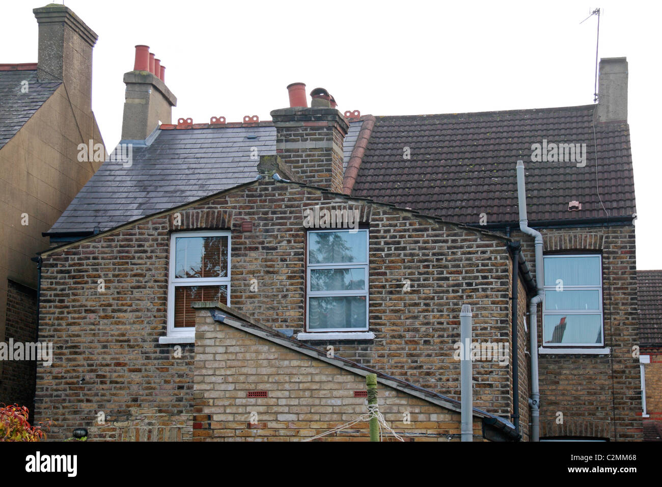 The rear view of a UK residential property (late Victorian) shortly before a roof/loft extension (on the left half of building). Stock Photo